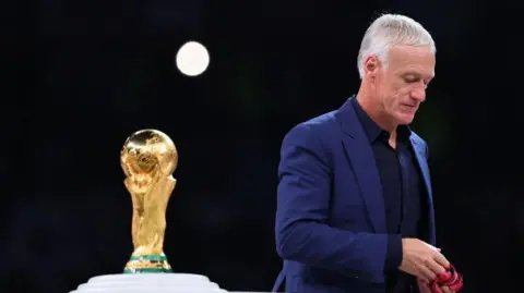 France Head Coach Didier Deschamps walks past the World Cup trophy in 2022 after losing the final to Argentina 