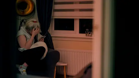 Blast Films Karen checks phone for news of her missing daughter, Larissa