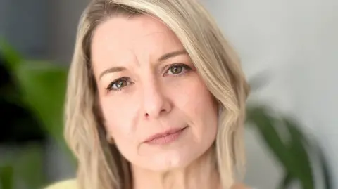 Wendy Griffth looks at the camera - she is a woman with blonde hair