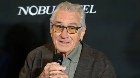 Mondadori Portfolio via Getty Images Actor Robert De Niro speaking into a microphone