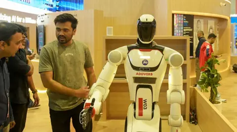 A man shows visitors a robot at the AI Summit