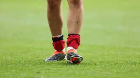 Getty Images A football player wearing small shin pads