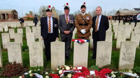 Crown Copyright Members of the Royal Regiment of Fusiliers stand by Sgt Bott's grave