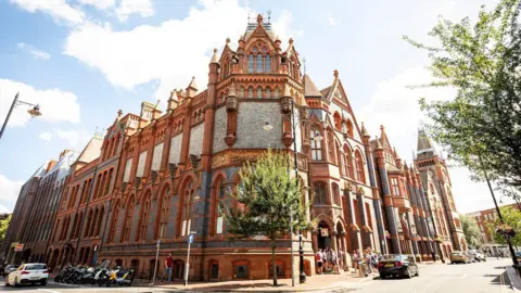 Reading Town Hall is a large grand-looking brick building with a stained glass window on the top of the tower at the front.