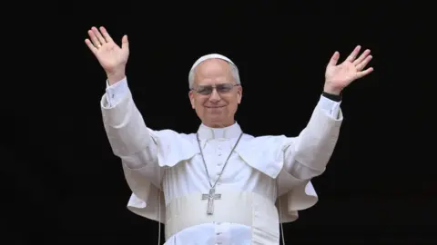 Pope Leo XIV waves and smiles