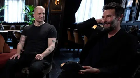 A picture of the author China Miéville and the actor Keanu Reeves