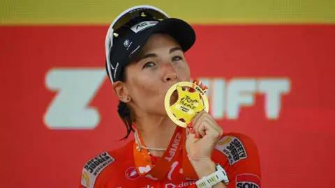 Kimberley Le Court kisses her winner's medal 