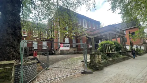 Exterior of the Friary in Derby which is three storeys tall and has boarded up windows.
