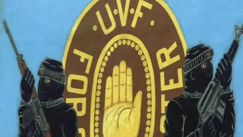 PA A UVF mural featuring two armed and masked men on a blue backdrop