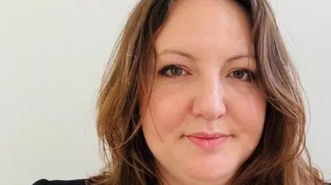 Tash Buckley A woman with brown hair looks at the camera.