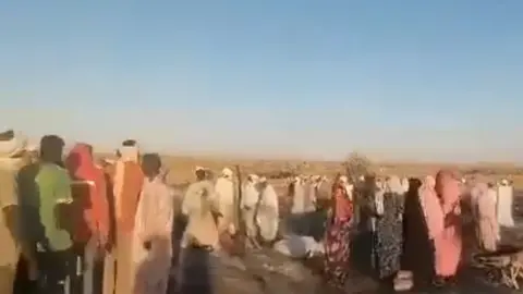 A screengrab showing people looking a the the site of the bombed market in rural Darfur, Sudan