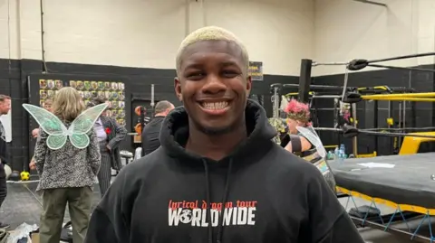Dereiss Gordon, who plays Lysander, smiling at the camera during rehearsals.
