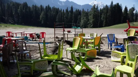 Reuters Chairs and tables are scattered at the site of a suspected militant attack on tourists in Baisaran near Pahalgam in south Kashmir's Anantnag district, April 24, 2025.