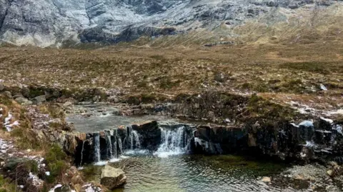 Amy Thornton Pools of water among greenspace and hills