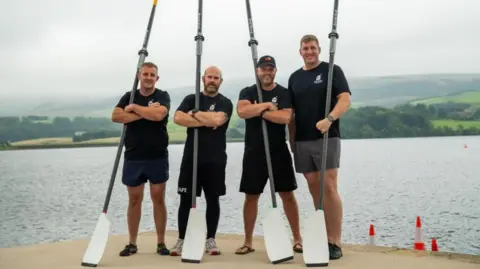 Dean Fitzmaurice, Nick Perks, Richard Hornsey and Matthew Pitchforth are standing on a pontoon wearing shorts and t-shirts and holding oars.