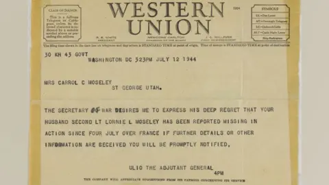IWM Duxford A Western Union telegram informing Carrol (sic) Moseley her husband was missing in action. It is light yellow and has Western Union in capitals along the top and underneath is typed details, including the date, who it's addressed to and brief details about when Lt Moseley was posted missing.