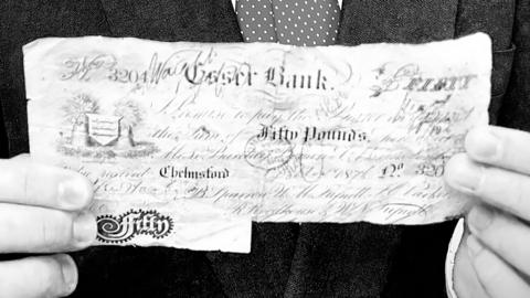 Boy holds rare £50 note dated 1876
