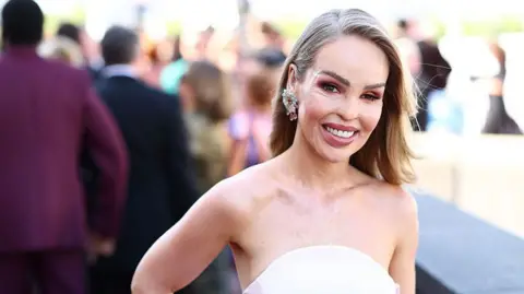 Katie Piper at the Bafta TV awards 2025, wearing a strapless white gown.