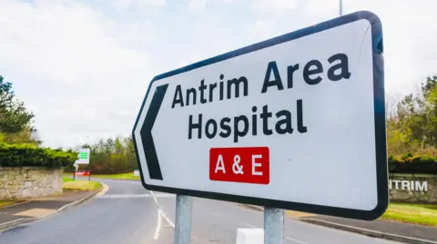 Getty Images Road sign that reads "Antrim Area Hospital A & E"