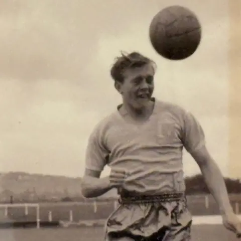 Ken Wagstaff A black and white image of a footballer heading a ball.