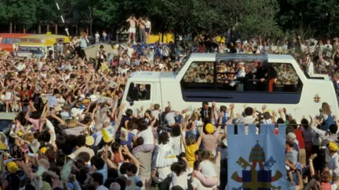 Getty The Pope-mobile drives down through Liverpool
