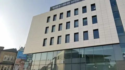 The front of a Tameside Council building on a sunny day