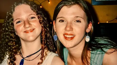 Emily Talbot is pictured with her sister Elizabeth. They are both young women but Emily has very curly hair whereas Elizabeth's is straight. They are both smiling.