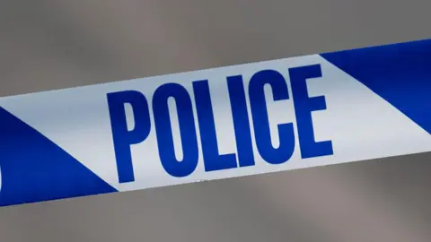 A close-up of blue and white police tape.