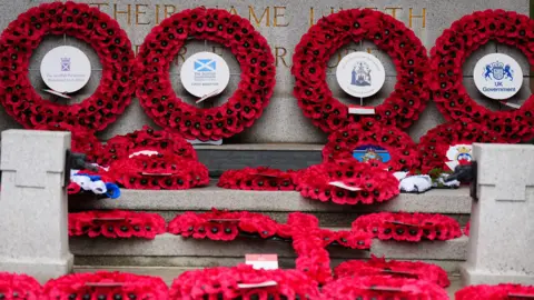 PA Media Red poppy wreaths laid at the Stone of Remembrance in Edinburgh.