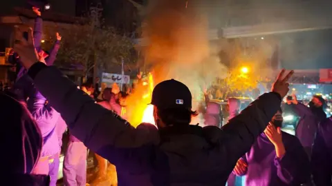 Fires are lit as protesters rally on January 8, 2026 in Tehran, Iran