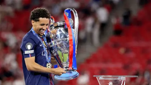 Marquinhos celebrates with the Champions League trophy