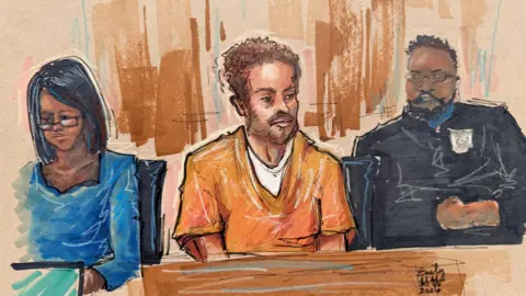 A 30 April 2026 courtroom sketch of Cole Tomas Allen, the suspect in the White House Correspondents' Dinner shooting, depicts him sitting in a courtroom in an orange jumper during a hearing after being charged with attempting to assassinate US President Donald Trump, in Washington DC.
