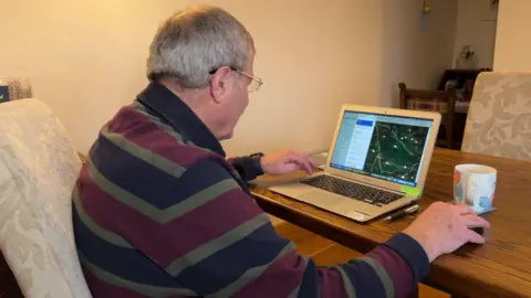 The chair of Murton Parish Council sits at computer