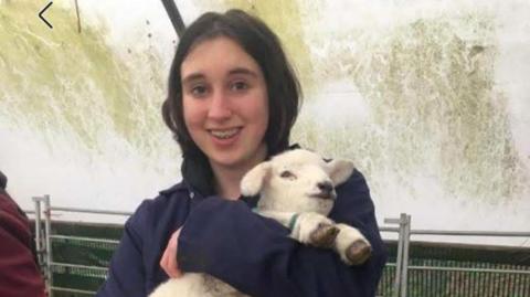 Jen Bridges-Chalkley holds a lamb