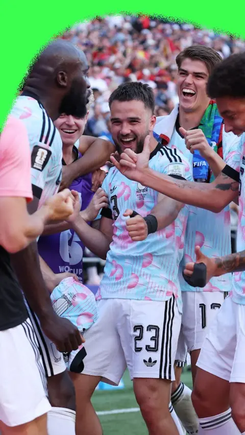 Belgium players celebrating a goal against the United States.