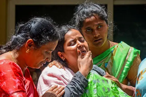 AFP via Getty Images Family members of a victim who died during the stampede outside the M. Chinnaswamy Stadium grieve in front of her body at their residence in the Yelahanka locality in Bengaluru on June 5, 2025. Virat Kohli said he was lost for words after celebrations of a dream IPL title turned to tragedy when 11 mainly young cricket fans were crushed to death in Bengaluru. Hundreds of thousands had packed the streets on June 4 to welcome home their hero Kohli and the Royal Challengers Bengaluru (RCB) after they had beaten Punjab Kings a day earlier in a thrilling Indian Premier League final. (Photo by AFP) (Photo by -/AFP via Getty Images)