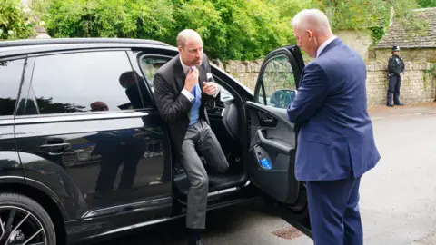 PA Media Prince William is getting out of a car.