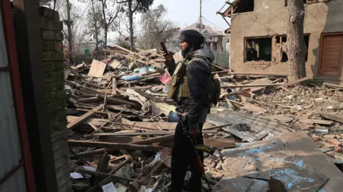  Photo by FAROOQ KHAN/EPA/Shutterstock (15793125f)
An Indian soldier takes a photograph of the demolished house of Umar Nabi, the primary suspect in the Delhi car blast, in his hometown of Koil, Pulwama district, south of Srinagar, Indian-administered Kashmir, 14 November 2025. Umar Nabi is accused of having driven the explosive-laden car that detonated near the Red Fort Metro station on 10 November.
House of Delhi blast key suspect demolished in Kashmir, Pulwama, India - 14 Nov 2025