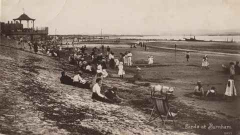 North Sedgemoor Local History Group A Victorian photograph showing people on the beach at Burnham, with a few sitting on deck chairs