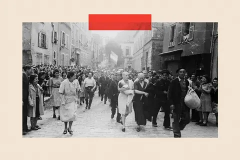 Getty Images A woman, with her baby, and her mother are jeered and humiliated by crowds in Chartres after having their heads shaved as punishment 