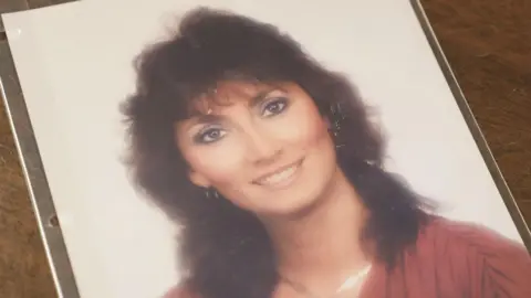 S4C A photo of Lisa Redd, whom Orme was convicted of killing in 1993. She has shoulder-length brown hair and wears silver hoop earrings and a red top - she is smiling at the camera.
