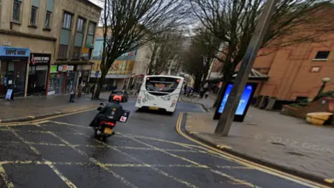 Google A view looking down Union Street in Bristol with a moped rider and bus visible