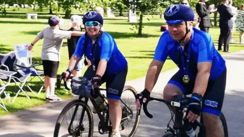 Martin Wiltshire Mr Wiltshire and his daughter cycling in a park