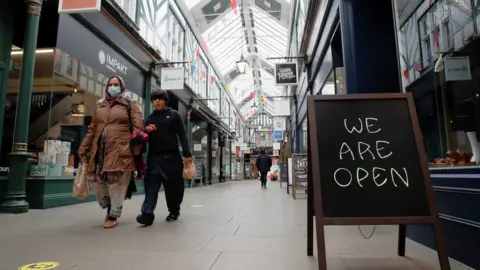 Reuters People walk at The Arcade shopping mall, amid the spread of coronavirus disease (COVID-19), in Bedford town centre,