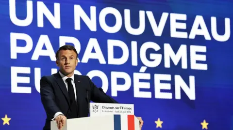 French President Emmanuel Macron delivers a speech on Europe next to a slogan reading 'A new European paradigm' in the amphitheatre of the Sorbonne University in Paris, France, 25 April 2024