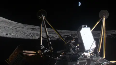 A photograph of Athena spacecraft on its side on the Moon's surface with Earth in the dark sky 