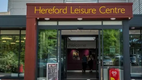 Herefordshire Council Entrance to Hereford Leisure Centre, with the name in yellow letters above the door.