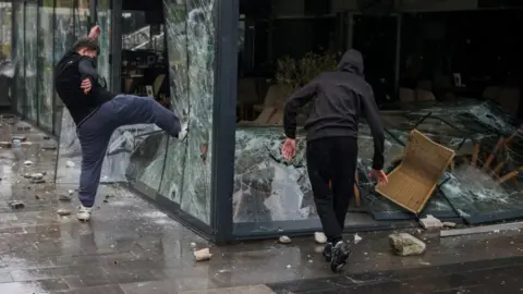 Reuters young people crush the windows and destroy a bar in Kocani