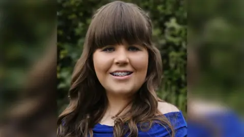 Family handout Mariella Rose has long brown hair and braces on her teeth and is wearing a blue top. She is smiling warmly at the camera.
