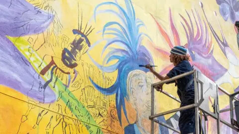 Hannah Platt and Wes Foster. Mural being created